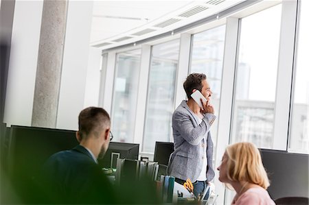 simsearch:649-07520071,k - Businessman talking on cell phone at office window Stock Photo - Premium Royalty-Free, Code: 6113-08784479