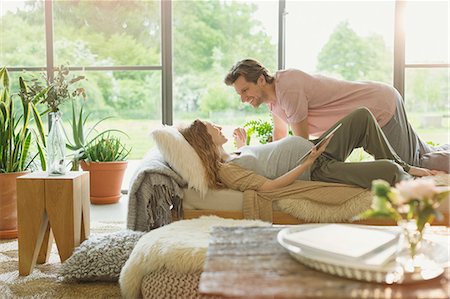 simsearch:6113-06720867,k - Affectionate pregnant couple laying on chaise Stock Photo - Premium Royalty-Free, Code: 6113-08721985