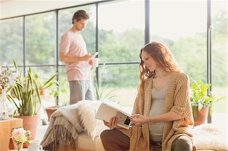 people sitting in chaise lounge - Pregnant woman reading book in living room Stock Photo - Premium Royalty-Free, Code: 6113-08722065