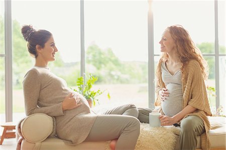 people sitting in chaise lounge - Pregnant women drinking tea and talking in living room Stock Photo - Premium Royalty-Free, Code: 6113-08722000