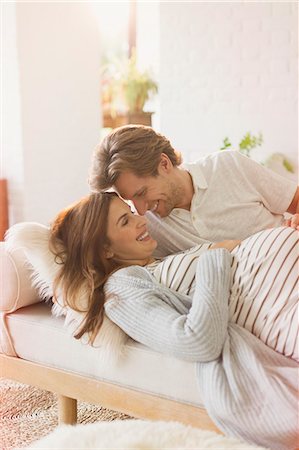 simsearch:6113-06720867,k - Pregnant couple laying and talking on chaise Stock Photo - Premium Royalty-Free, Code: 6113-08722021