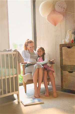 Pregnant mother and daughter reading story book in nursery Stock Photo - Premium Royalty-Free, Code: 6113-08722029