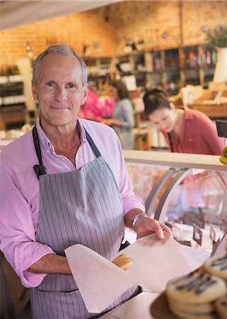 simsearch:6113-07589172,k - Portrait smiling deli worker in grocery store Stock Photo - Premium Royalty-Free, Code: 6113-08722141