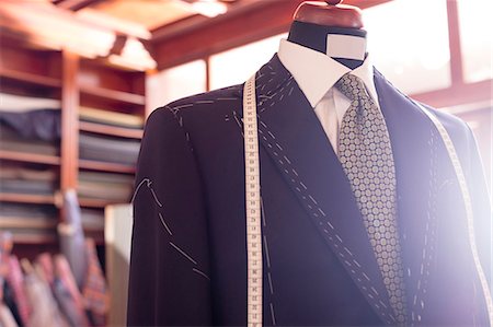 Close up tailored suit and tape measure on dressmakers model in menswear shop Stock Photo - Premium Royalty-Free, Code: 6113-08722296