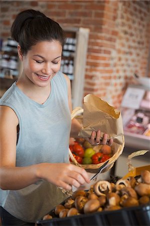 Smiling woman shopping for mushrooms in market Photographie de stock - Premium Libres de Droits, Code: 6113-08722200