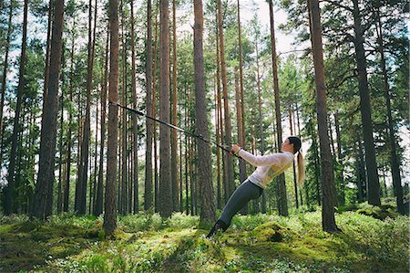simsearch:695-05768377,k - Runner using resistance band on tree in woods Stock Photo - Premium Royalty-Free, Code: 6113-08722217