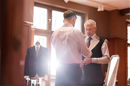 Tailor fitting businessman for suit in menswear shop Stock Photo - Premium Royalty-Free, Code: 6113-08722361