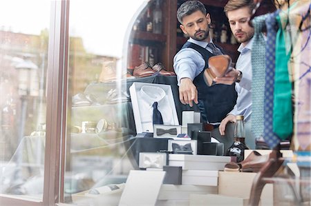 dress shoes for men - Worker showing businessman merchandise in window of menswear shop Stock Photo - Premium Royalty-Free, Code: 6113-08722306