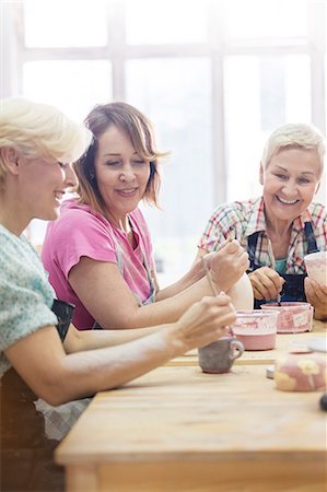 Smiling mature women painting pottery in studio Stock Photo - Premium Royalty-Free, Code: 6113-08722420