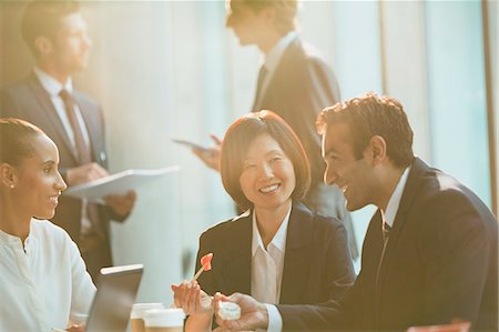 simsearch:6113-07565839,k - Business people eating lunch with chopsticks in conference room meeting Stock Photo - Premium Royalty-Free, Code: 6113-08882444