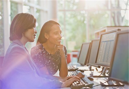 simsearch:614-02985269,k - Businesswomen working at computer in office Stock Photo - Premium Royalty-Free, Code: 6113-08882478