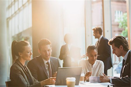 sunny work - Business people working at laptop and reviewing paperwork in meeting Stock Photo - Premium Royalty-Free, Code: 6113-08882409