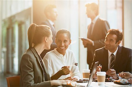 Business people eating lunch with chopsticks in conference room meeting Stock Photo - Premium Royalty-Free, Code: 6113-08882436