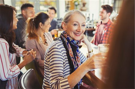 simsearch:6113-07147381,k - Smiling senior woman drinking and talking with friend at bar Stock Photo - Premium Royalty-Free, Code: 6113-08882598