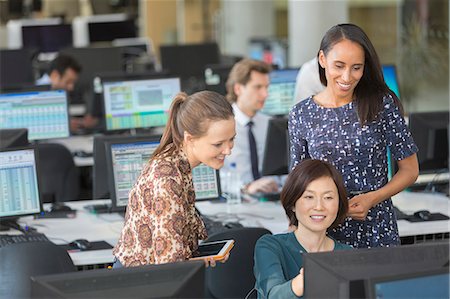 simsearch:614-02985269,k - Businesswomen using computer in open plan office Stock Photo - Premium Royalty-Free, Code: 6113-08882508