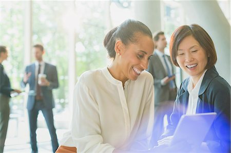 simsearch:614-02985269,k - Businesswomen using digital tablet in office lobby Stock Photo - Premium Royalty-Free, Code: 6113-08882524