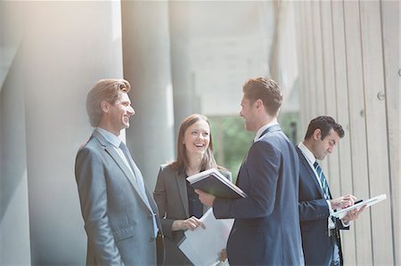 simsearch:6113-07243187,k - Business people talking and laughing in sunny office lobby Stock Photo - Premium Royalty-Free, Code: 6113-08882530