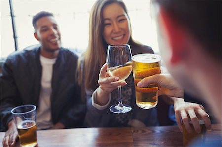simsearch:6113-06909171,k - Friends celebrating, toasting beer and wine at table in bar Stock Photo - Premium Royalty-Free, Code: 6113-08882663