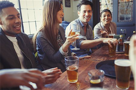 simsearch:6113-06909171,k - Friends drinking beer and wine and talking at table in bar Stock Photo - Premium Royalty-Free, Code: 6113-08882660