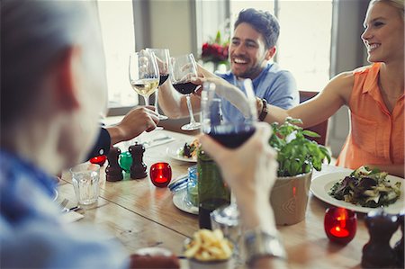 dinner - Smiling friends celebrating, toasting wine glasses at restaurant table Stock Photo - Premium Royalty-Free, Code: 6113-08882662