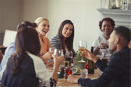 simsearch:6113-06909171,k - Friends drinking wine and talking at restaurant table Stock Photo - Premium Royalty-Free, Code: 6113-08882685