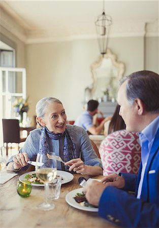 simsearch:6113-07242109,k - Senior couple talking and dining at restaurant table Stock Photo - Premium Royalty-Free, Code: 6113-08882688