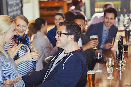 simsearch:6113-07543030,k - Enthusiastic man and woman greeting in bar Stock Photo - Premium Royalty-Free, Code: 6113-08882630