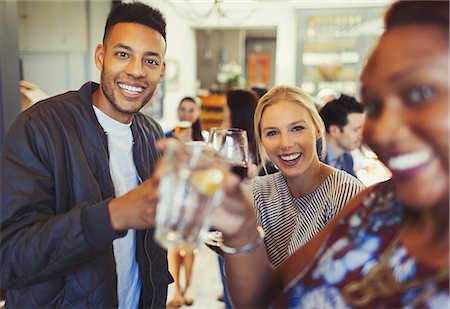 simsearch:6113-06909171,k - Portrait smiling man drinking with friends in bar Stock Photo - Premium Royalty-Free, Code: 6113-08882638