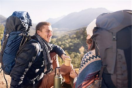 Young couple with backpacks hiking, taking a break and drinking coffee Stock Photo - Premium Royalty-Free, Code: 6113-08882785