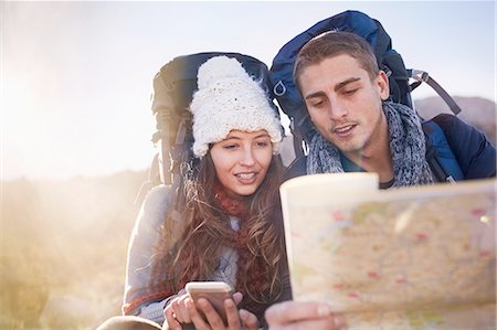 eco tourism - Young couple with backpacks hiking, checking map Stock Photo - Premium Royalty-Free, Code: 6113-08882811