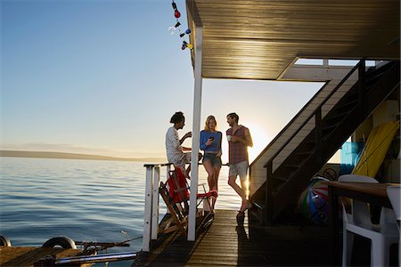 simsearch:6113-08743448,k - Young adult friends hanging out on summer houseboat on ocean Stock Photo - Premium Royalty-Free, Code: 6113-08805302