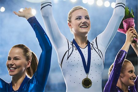 Female gymnasts celebrating victory waving on winners podium Stock Photo - Premium Royalty-Free, Code: 6113-08805440