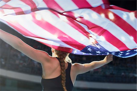 perfect fit - Female athlete running victory lap with American flag Stock Photo - Premium Royalty-Free, Code: 6113-08805421