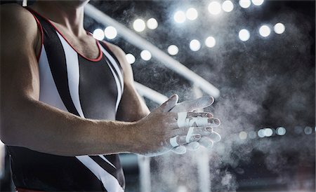 sports event - Male gymnast rubbing chalk powder on hands below parallel bars Stock Photo - Premium Royalty-Free, Code: 6113-08805434