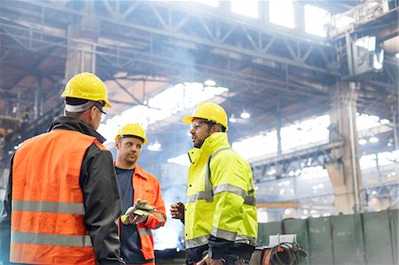 Steel workers talking in factory Stock Photo - Premium Royalty-Free, Code: 6113-08805549