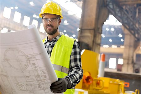 simsearch:6113-08722278,k - Portrait smiling engineer with blueprints ins steel factory Stock Photo - Premium Royalty-Free, Code: 6113-08805564