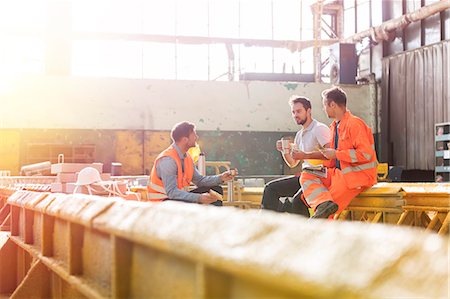 simsearch:6113-08805556,k - Steel workers enjoying lunch break in factory Stock Photo - Premium Royalty-Free, Code: 6113-08805571