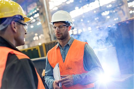 safety glasses - Steel workers talking in factory Stock Photo - Premium Royalty-Free, Code: 6113-08805581