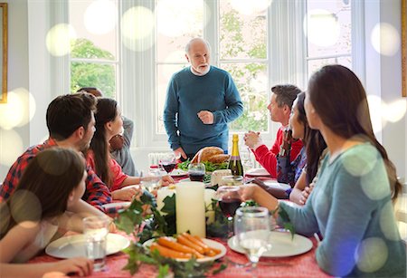 ethnic families at thanksgiving - Grandfather preparing to carve Christmas turkey at dinner table Stock Photo - Premium Royalty-Free, Code: 6113-08805677