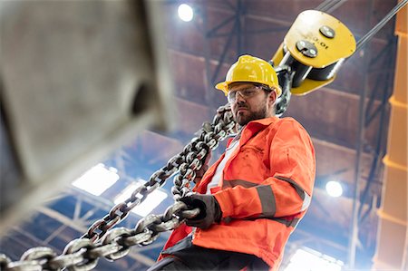 simsearch:6113-08805556,k - Steel worker holding crane chain in factory Stock Photo - Premium Royalty-Free, Code: 6113-08805602