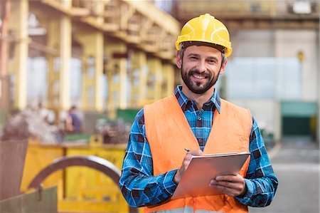 simsearch:6113-08805556,k - Portrait smiling steel worker with clipboard in factory Stock Photo - Premium Royalty-Free, Code: 6113-08805618