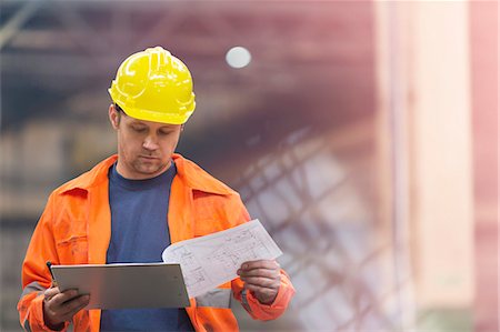 simsearch:6113-08805556,k - Steel worker reviewing blueprints in factory Stock Photo - Premium Royalty-Free, Code: 6113-08805620