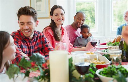 family man dinner table - Portrait smiling woman enjoying Christmas dinner with family at table Stock Photo - Premium Royalty-Free, Code: 6113-08805634