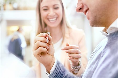 simsearch:6113-07791158,k - Jeweler helping man shopping for diamond ring in jewelry store Stock Photo - Premium Royalty-Free, Code: 6113-08805732