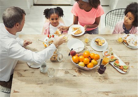 simsearch:649-07437620,k - Multi-ethnic family eating breakfast at table Stock Photo - Premium Royalty-Free, Code: 6113-08943593
