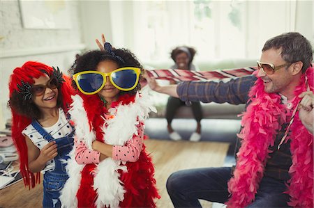 simsearch:6113-07148073,k - Portrait father and daughters playing dress up with oversized sunglasses and feather boas Stock Photo - Premium Royalty-Free, Code: 6113-08943594