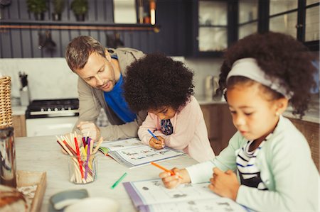 simsearch:649-01696512,k - Multi-ethnic father and daughters coloring in kitchen Stock Photo - Premium Royalty-Free, Code: 6113-08943649