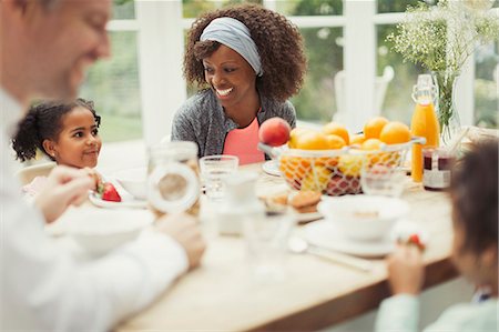 simsearch:6113-07147647,k - Multi-ethnic young family eating breakfast at table Stock Photo - Premium Royalty-Free, Code: 6113-08943678