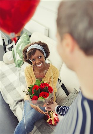 simsearch:6113-07790495,k - Husband giving Valentine's Day rose bouquet and balloon to wife Stock Photo - Premium Royalty-Free, Code: 6113-08943620