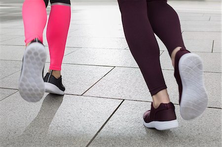 simsearch:633-01715682,k - Close up feet of female runners jogging Stock Photo - Premium Royalty-Free, Code: 6113-08943723